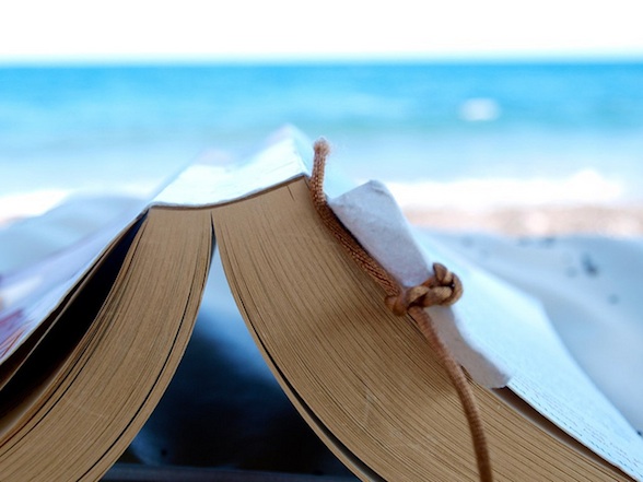 IMAGE Reading a book at the beach IMAGE