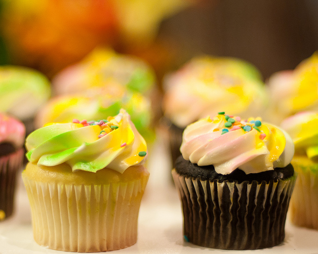 Cupcakes with yellow, green, and white frosting