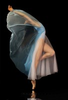 IMAGE A ballet dancer draped in a blue and white chiffon dress arches her back as sheer fabric covers her face and arms. IMAGE