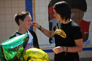 IMAGE A teacher warmly congratulates her student. IMAGE