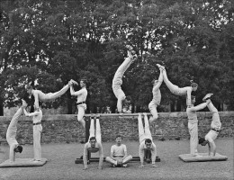 A group of 12 'gym class' participants create an architectural-looking pose for the camera in this vintage black and white photograph.