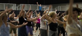 Jamie leads a large group of dancers