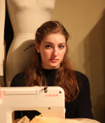 Toya Dubin with the sewing machine she uses to build dance costumes.