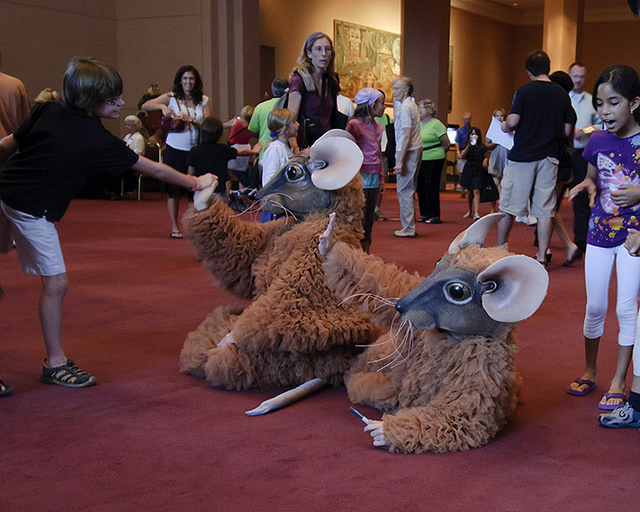 Dancers dressed like Nutcracker mice greet peope in theater lobby