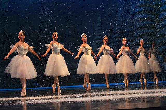 Dancers onstage in white tutus for Nutcracker snow scene