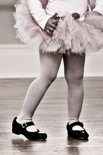 The legs of a child in tutu and tap shoes
