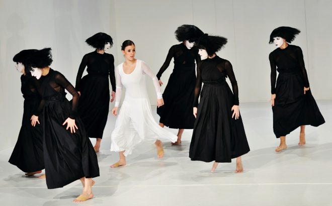 Dramatic dance piece with painted faces and girl in white